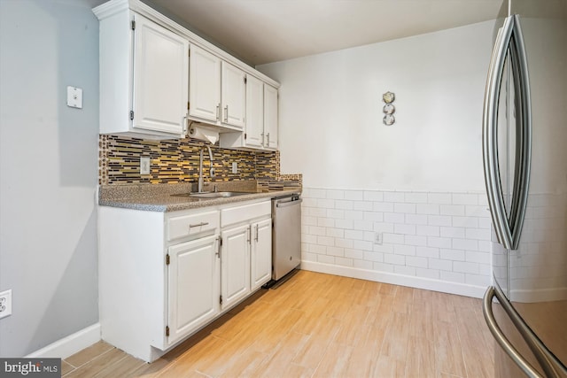 2557 Peter Jefferson Ln, Herndon, VA 20171 - kitchen with stainless steel appliances, a sink, white cabinetry, and light wood-style flooring