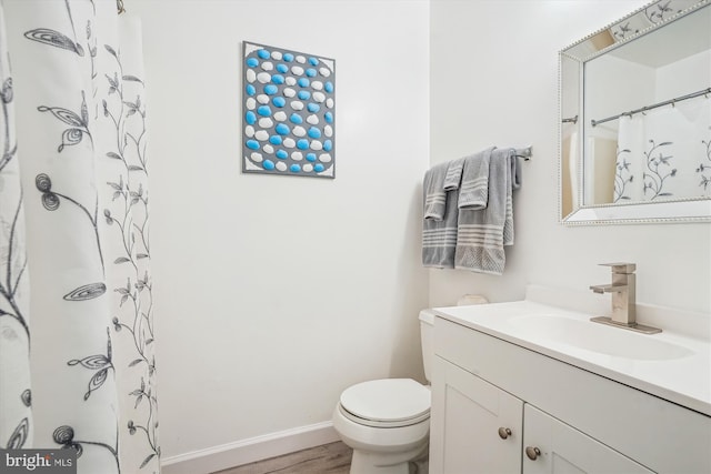 2557 Peter Jefferson Ln, Herndon, VA 20171 - bathroom with vanity, toilet, wood finished floors, baseboards, and a shower with curtain