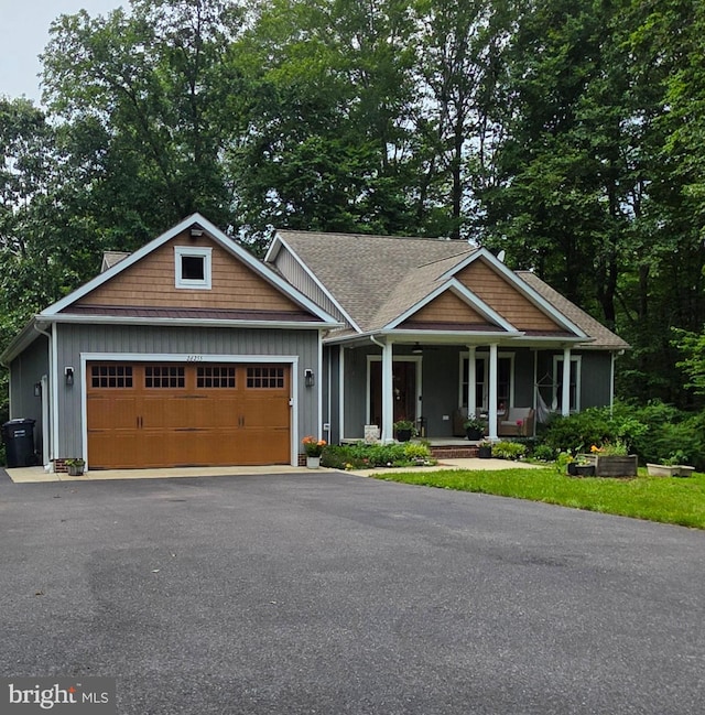 26255 Rison Ln, Mechanicsville, MD 20659 - craftsman house featuring a porch, an attached garage, and asphalt driveway