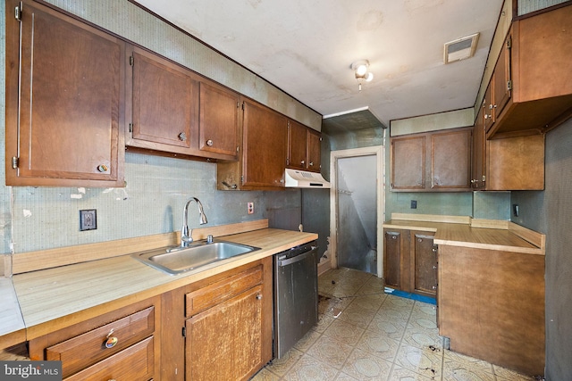 907 W Twenty Fifth St, Wilmington, DE 19802 - kitchen featuring a sink, dishwasher, light countertops, under cabinet range hood, and brown cabinetry