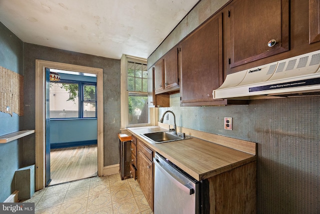 907 W Twenty Fifth St, Wilmington, DE 19802 - kitchen featuring dishwasher, a sink, under cabinet range hood, light tile patterned floors, and light countertops