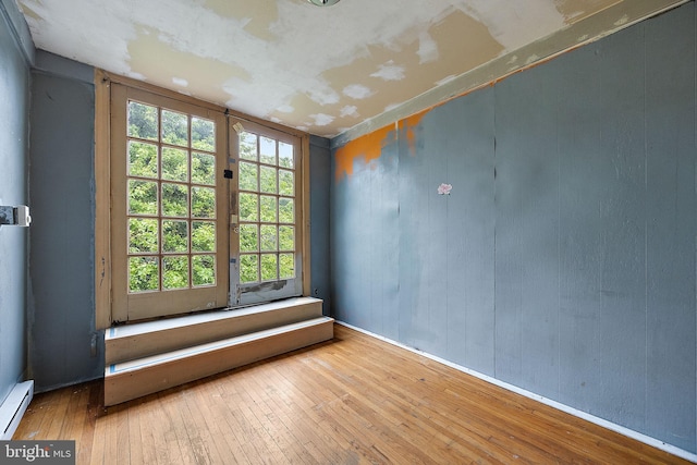 907 W Twenty Fifth St, Wilmington, DE 19802 - spare room with wood-type flooring, a baseboard heating unit, and baseboards