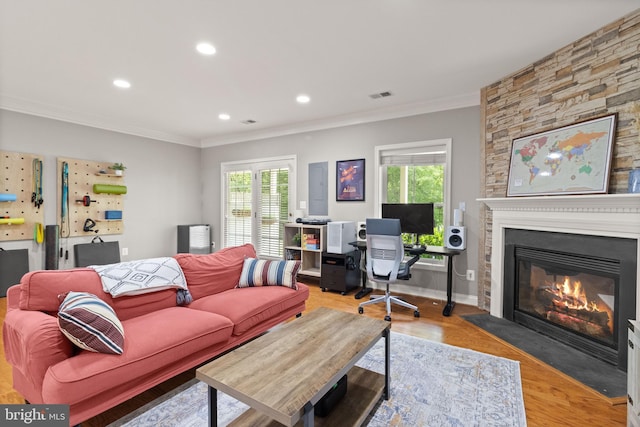 504 Hollingsworth Ter, Herndon, VA 20170 - living area featuring a fireplace with flush hearth, crown molding, recessed lighting, and light wood-type flooring