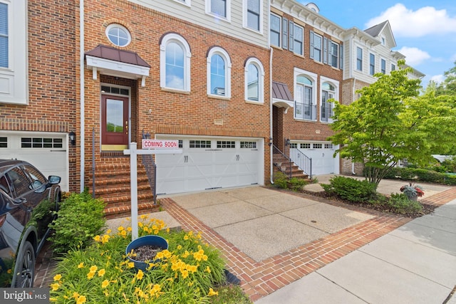 504 Hollingsworth Ter, Herndon, VA 20170 - view of front of property featuring a garage, brick siding, and driveway