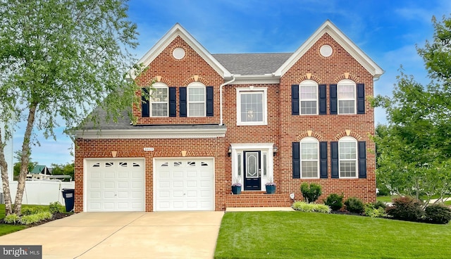 24655 Broad Creek Dr, Hollywood, MD 20636 - colonial home with a front yard, brick siding, driveway, and a garage