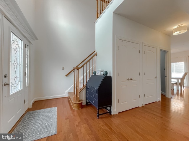 24655 Broad Creek Dr, Hollywood, MD 20636 - foyer entrance with light wood finished floors, stairs, and baseboards