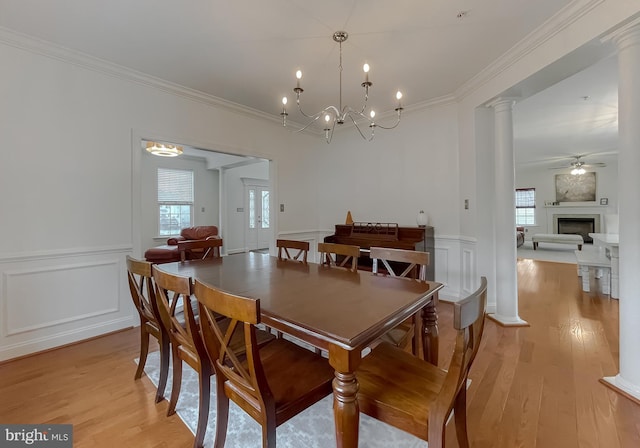 24655 Broad Creek Dr, Hollywood, MD 20636 - dining space with a decorative wall, light wood-style floors, crown molding, a ceiling fan, and a wainscoted wall