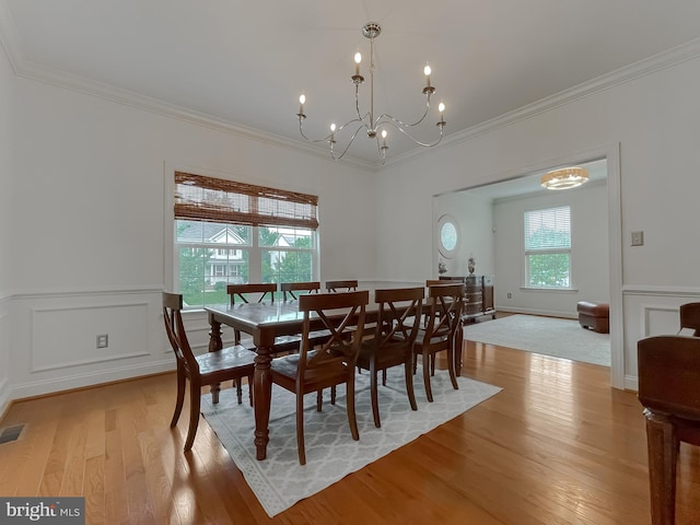 24655 Broad Creek Dr, Hollywood, MD 20636 - dining space with a chandelier, crown molding, light wood finished floors, and wainscoting
