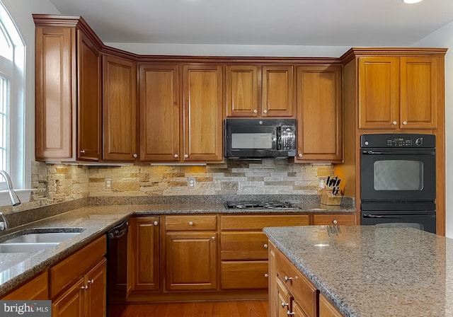24655 Broad Creek Dr, Hollywood, MD 20636 - kitchen featuring black appliances, a sink, light stone countertops, and brown cabinets
