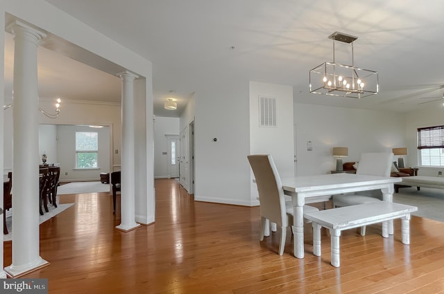 24655 Broad Creek Dr, Hollywood, MD 20636 - dining room featuring decorative columns, wood finished floors, plenty of natural light, and baseboards