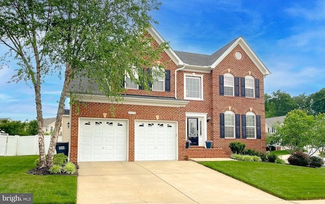 24655 Broad Creek Dr, Hollywood, MD 20636 - colonial inspired home featuring a garage, concrete driveway, and brick siding