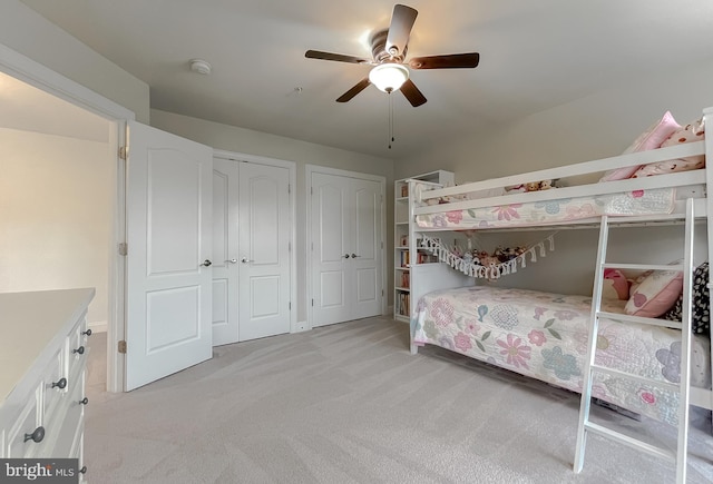 24655 Broad Creek Dr, Hollywood, MD 20636 - bedroom featuring multiple closets, light carpet, and a ceiling fan