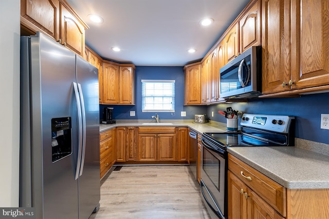 1088 Locust Dr, Pasadena, MD 21122 - kitchen featuring stainless steel appliances, a sink, brown cabinets, recessed lighting, and light wood-type flooring