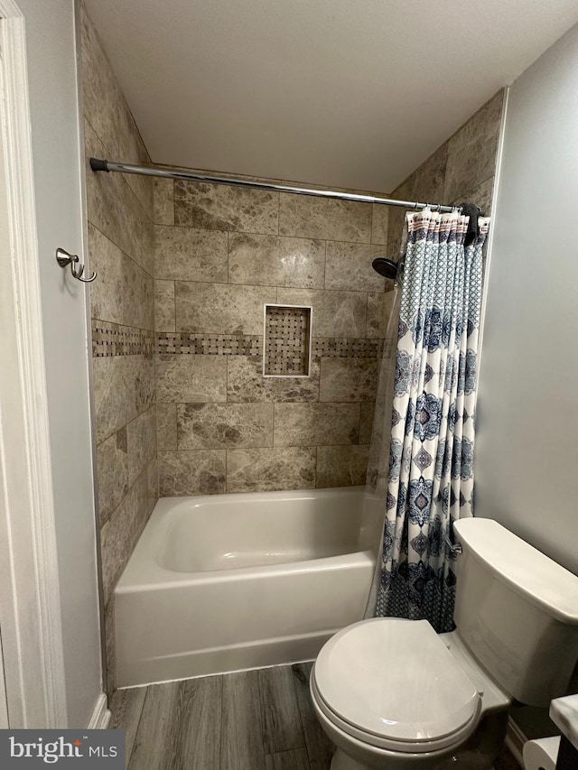 1088 Locust Dr, Pasadena, MD 21122 - bathroom featuring shower / bathtub combination with curtain, toilet, and wood finished floors