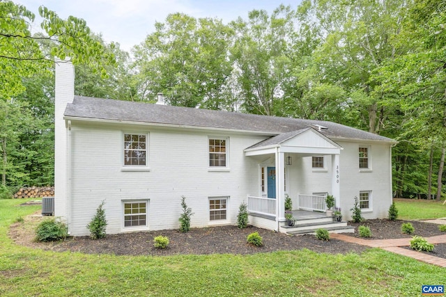 3500 Monacan Dr W, Charlottesville, VA 22901 - split level home with a chimney, a porch, a front lawn, brick siding, and central air condition unit