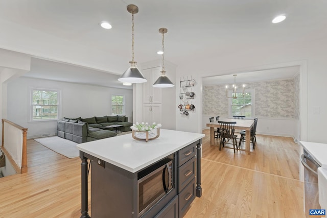 3500 Monacan Dr W, Charlottesville, VA 22901 - kitchen with light wood-style floors, wainscoting, black microwave, light countertops, and a chandelier