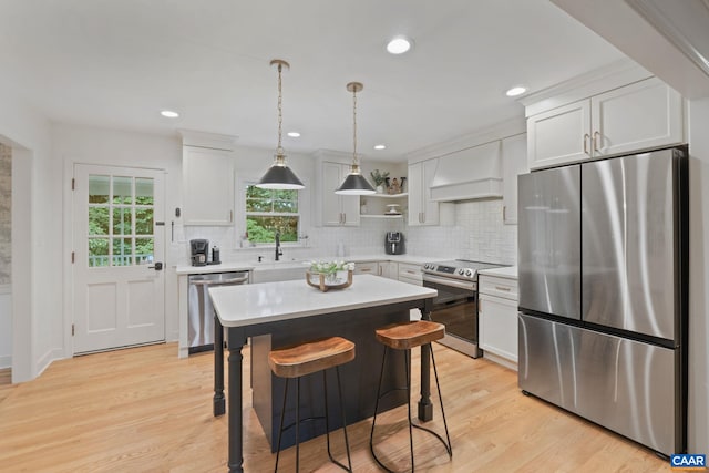 3500 Monacan Dr W, Charlottesville, VA 22901 - kitchen featuring appliances with stainless steel finishes, custom range hood, light countertops, tasteful backsplash, and white cabinetry