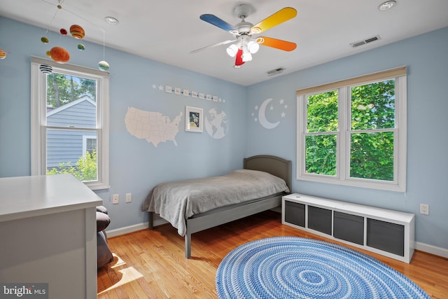 5613 Glenwood Rd, Bethesda, MD 20817 - bedroom featuring multiple windows, light wood-style floors, baseboards, and ceiling fan
