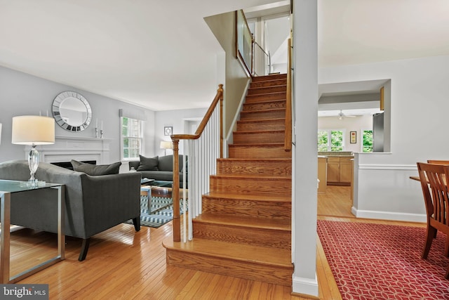 5613 Glenwood Rd, Bethesda, MD 20817 - stairs featuring hardwood / wood-style floors, plenty of natural light, a fireplace, and a ceiling fan