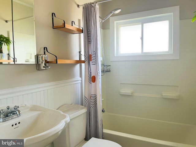 920 Vanderwood, Baltimore, MD 21228 - bathroom featuring a sink, toilet, shower / bathtub combination with curtain, and wainscoting