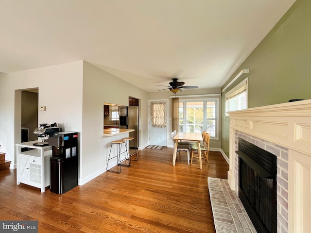 920 Vanderwood, Baltimore, MD 21228 - dining space featuring ceiling fan, wood finished floors, a fireplace, and baseboards