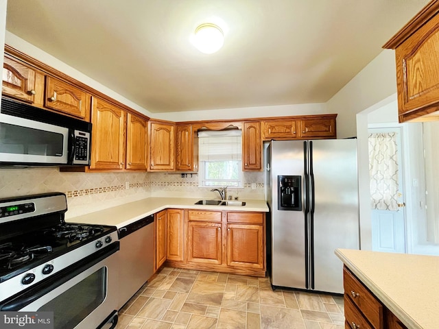 920 Vanderwood, Baltimore, MD 21228 - kitchen featuring appliances with stainless steel finishes, a sink, light countertops, tasteful backsplash, and brown cabinets