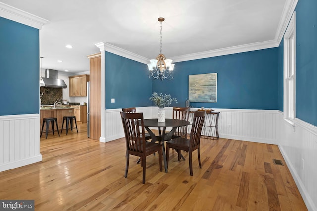1109 Cherry Point Rd, West River, MD 20778 - dining space featuring wainscoting, a chandelier, ornamental molding, light wood-style floors, and recessed lighting