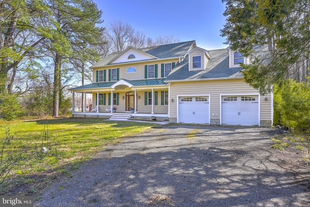1109 Cherry Point Rd, West River, MD 20778 - view of front facade featuring covered porch, an attached garage, driveway, and a front yard