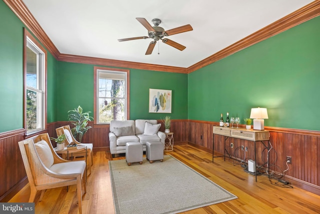 1109 Cherry Point Rd, West River, MD 20778 - living room with a wainscoted wall, a ceiling fan, wood finished floors, wood walls, and crown molding