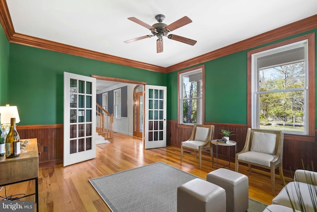 1109 Cherry Point Rd, West River, MD 20778 - sitting room featuring french doors, wainscoting, crown molding, stairs, and a ceiling fan