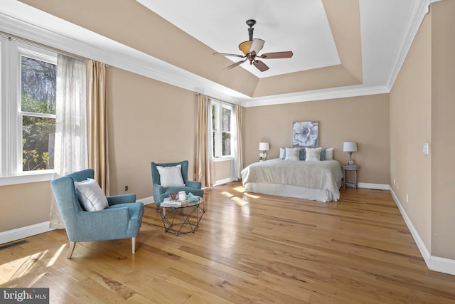 1109 Cherry Point Rd, West River, MD 20778 - bedroom with multiple windows, a raised ceiling, baseboards, wood finished floors, and ornamental molding
