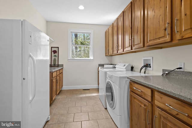 1109 Cherry Point Rd, West River, MD 20778 - washroom featuring cabinet space, baseboards, light tile patterned floors, and separate washer and dryer