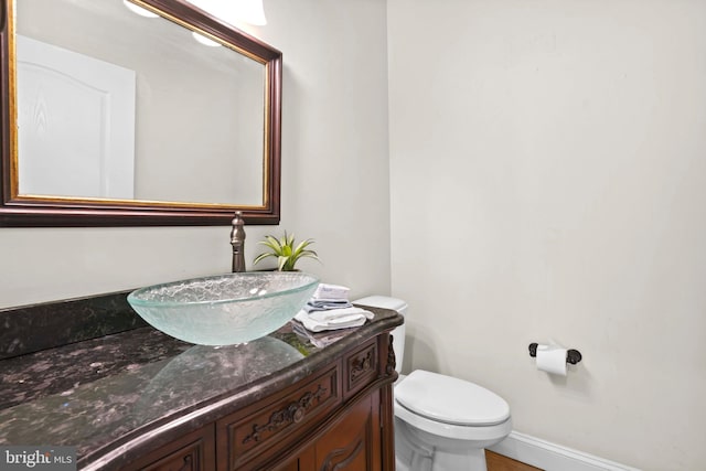 1109 Cherry Point Rd, West River, MD 20778 - bathroom with vanity, toilet, and baseboards