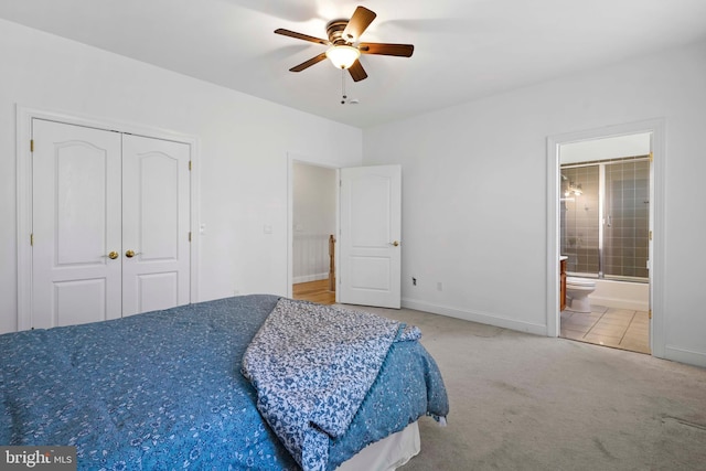 1109 Cherry Point Rd, West River, MD 20778 - carpeted bedroom featuring a closet, baseboards, a ceiling fan, and ensuite bath