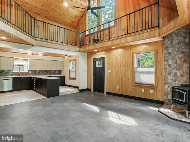 44 Wild Rose Ct, Hedgesville, WV 25427 - unfurnished living room featuring high vaulted ceiling, a wood stove, plenty of natural light, a ceiling fan, and baseboards