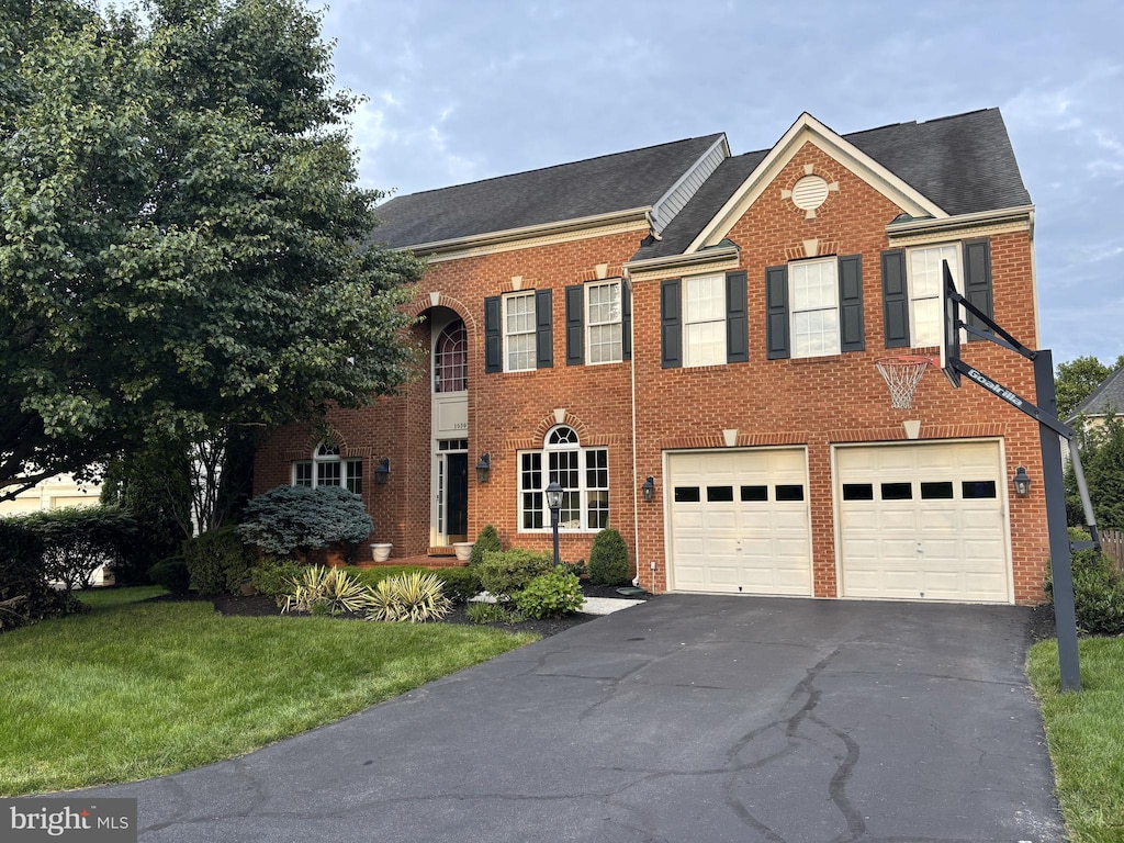19397 Mill Dam Pl, Leesburg, VA 20176 - view of front of property with driveway, brick siding, a front yard, a garage, and roof with shingles