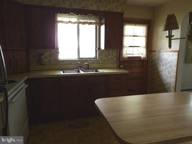 179 Mount Pleasant St, Frostburg, MD 21532 - kitchen featuring a sink, light countertops, stove, and wallpapered walls