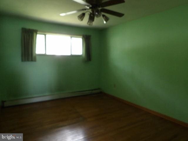 179 Mount Pleasant St, Frostburg, MD 21532 - unfurnished room with a baseboard heating unit, ceiling fan, wood finished floors, and baseboards