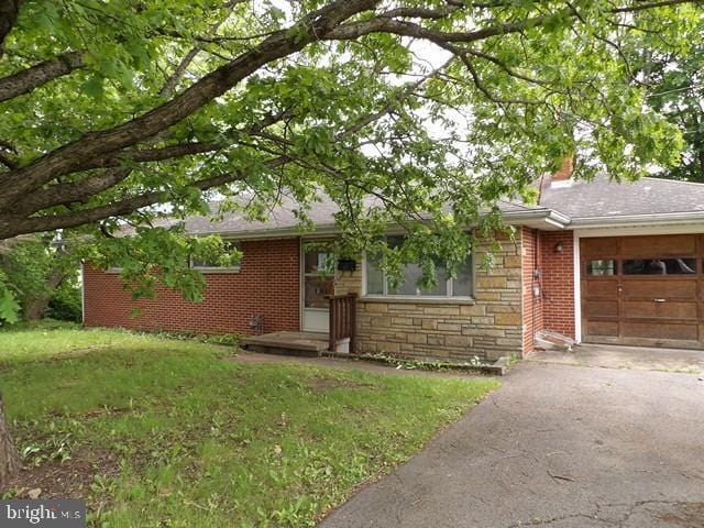 179 Mount Pleasant St, Frostburg, MD 21532 - ranch-style home featuring a garage, stone siding, asphalt driveway, a chimney, and a front lawn