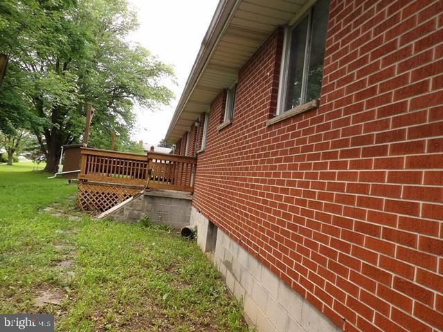 179 Mount Pleasant St, Frostburg, MD 21532 - view of side of home featuring brick siding, a yard, and a wooden deck
