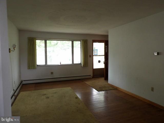 179 Mount Pleasant St, Frostburg, MD 21532 - spare room featuring a baseboard radiator, wood finished floors, and baseboards