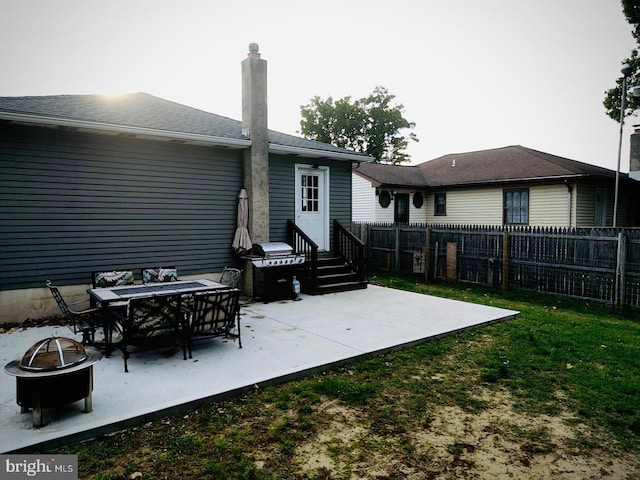 127 Greenwich Ave, Paulsboro, NJ 08066 - rear view of property featuring an outdoor fire pit, a patio area, a chimney, and entry steps