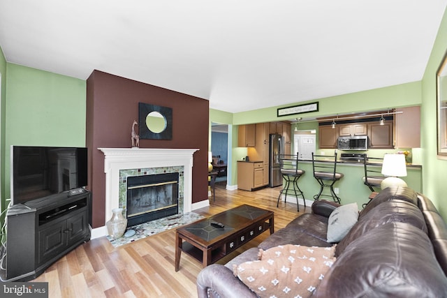 1319 Gwynedale Way, Lansdale, PA 19446 - living area with light wood finished floors, a fireplace with flush hearth, and baseboards