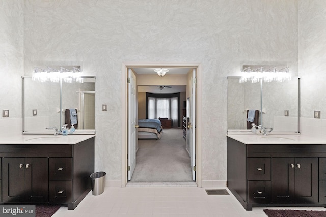 1319 Gwynedale Way, Lansdale, PA 19446 - bathroom featuring two vanities, a stall shower, baseboards, and connected bathroom