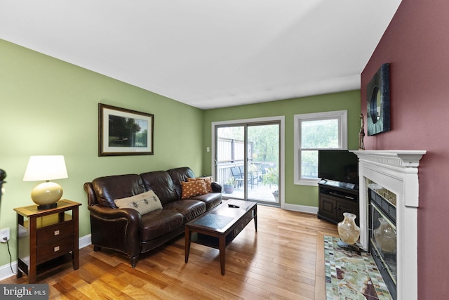 1319 Gwynedale Way, Lansdale, PA 19446 - living area with light wood-type flooring, baseboards, and a fireplace with flush hearth