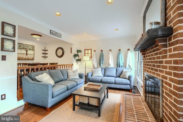 23 Faraday Dr, Lutherville Timonium, MD 21093 - living area featuring ornamental molding, wood finished floors, a brick fireplace, and recessed lighting