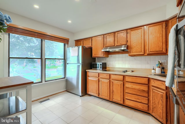 23 Faraday Dr, Lutherville Timonium, MD 21093 - kitchen featuring stainless steel appliances, under cabinet range hood, light countertops, backsplash, and recessed lighting