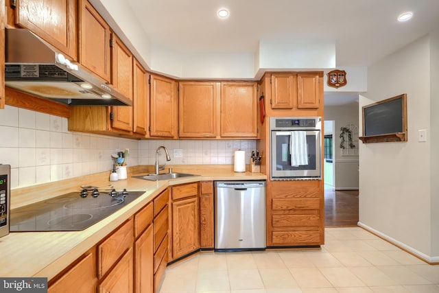 23 Faraday Dr, Lutherville Timonium, MD 21093 - kitchen featuring appliances with stainless steel finishes, a sink, range hood, decorative backsplash, and recessed lighting