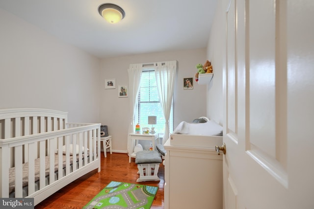 23 Faraday Dr, Lutherville Timonium, MD 21093 - bedroom featuring wood finished floors, a nursery area, and baseboards