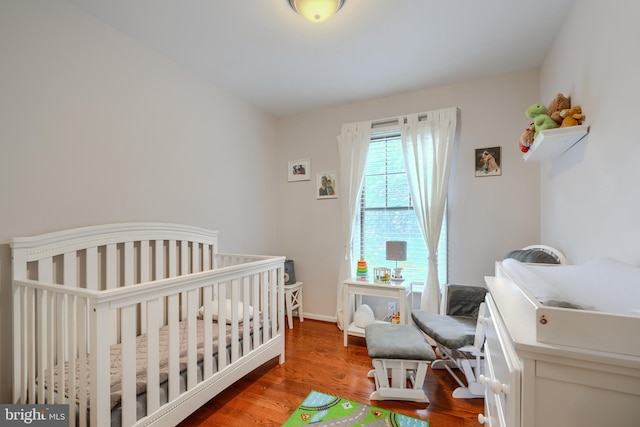 23 Faraday Dr, Lutherville Timonium, MD 21093 - bedroom featuring wood finished floors, a crib, and baseboards